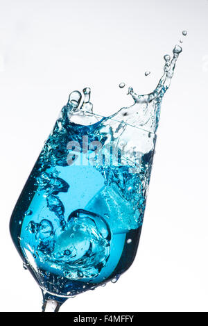 Wine glass isolated on white background with splashing water from an ice cube Stock Photo