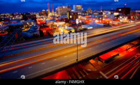 Freeway traffic moves through Spokane, Washington as night falls Stock Photo