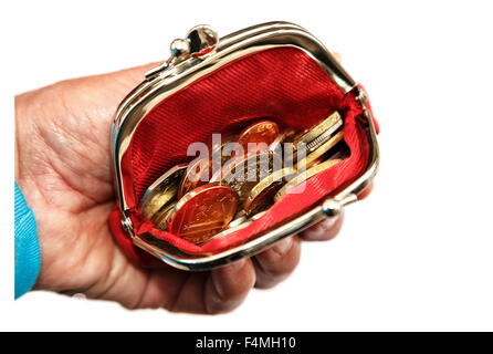 Pensioner's hand holding a red open coin purse with money sterling coins GBP isolated on a white background Cash in hand concept England UK Britain Stock Photo