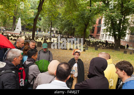 Tourists on a guided tour with tour guide, on the Boston Freedom Trail, the Old Granary Burial Ground, Boston, Massachusetts USA Stock Photo
