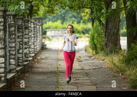 Young girl during a morning jog in the Park.