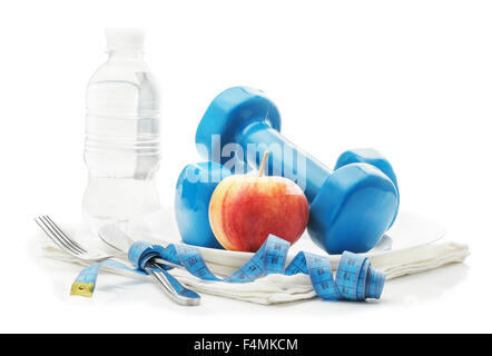 The concept of  healthy lifestyle, diet, sports, weight loss, fitness, sport.  Centimeter, dumbbells, apple on a plate, knife an Stock Photo