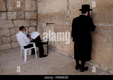 Ultra Orthodox Jewish worshipers praying at the Western Wall or Kotel in the old city East Jerusalem, Israel Stock Photo