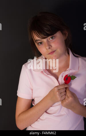 young girl showing respect for British legion poppy appeal for Remembrance Sunday November 08th 2015 Stock Photo