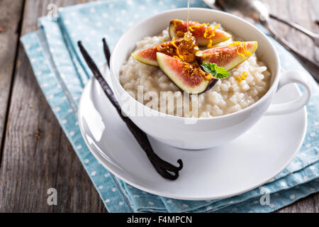 Rice pudding with milk and vanilla beans garnished with figs Stock Photo