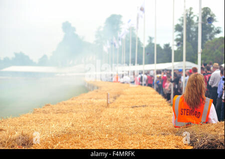 A woman in an orange Steward bib at the Goodwood Festival of Speed in the UK. Stock Photo