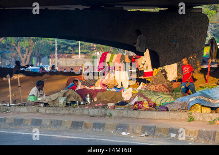 People are living under extrem conditions in tents and huts made from blankets under highway bridges Stock Photo