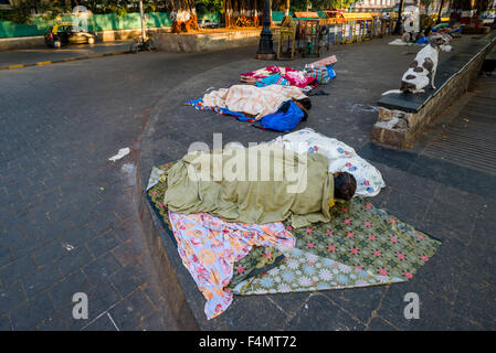 Homeless people are living under extrem conditions, sleeping on the pedestrian path Stock Photo