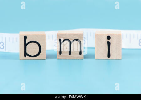 BMI body mass index letter blocks with tape measure. Stock Photo