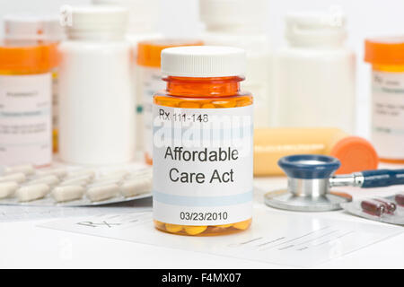 Affordable Care Act pill bottle with prescription and medical supplies.  Labels and all information contained therein are fictit Stock Photo