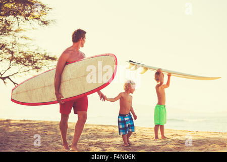 Father and sons going surfing together. Summer fun outdoor lifestyle Stock Photo