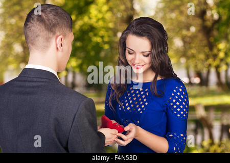 Young man makes a proposal to his girlfriend Stock Photo