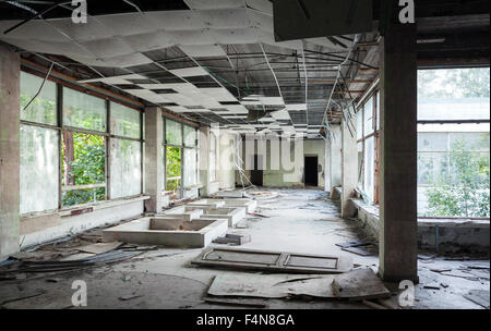 Abandoned building interior. Hall perspective with dirt on the floor Stock Photo