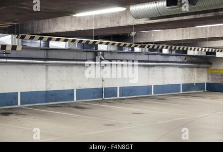 Empty underground parking interior, concrete walls and floor Stock Photo