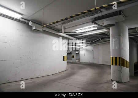 Empty underground parking interior, concrete walls and columns Stock Photo