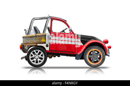 Small buggy car assembled from spare parts. Side view isolated on white background with reflection and soft shadow. Photo collag Stock Photo