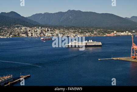 Cruise ship in the waters of the Burrard Inlet in Vancouver, Canada.   North shore mountains and city.  Canadian West Coast. Stock Photo
