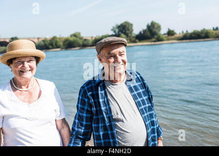 Germany, Ludwigshafen, portrait of happy senior couple at riverside Stock Photo