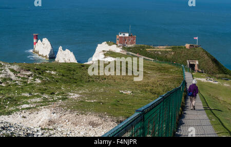 The Needles Victorian Old Battery with lady walking down a path to the entrance, Isle of Wight, England, UK Stock Photo