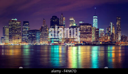 Vintage toned Manhattan skyline at night, NYC, USA. Stock Photo