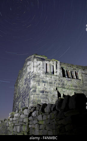 Derelict farm at Cruttonstall, near Hebden Bridge, West Yorkshire, UK with star trails Stock Photo