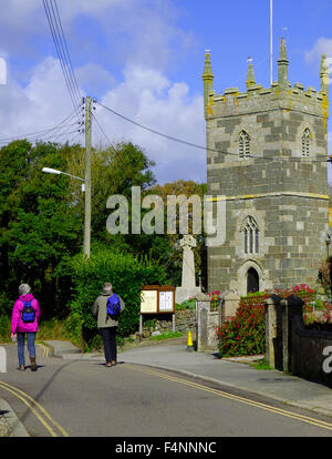 Walkers in Mullion Village, Lizard Peninsula, Cornwall, England, UK in Summer Stock Photo