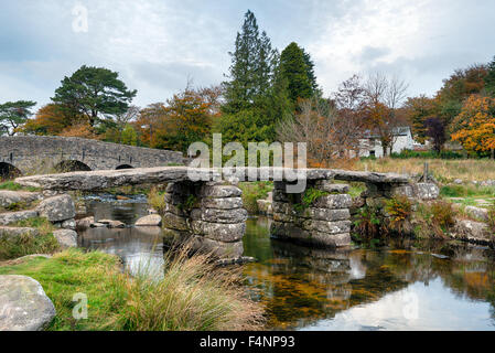 An ancient granite clapper bridge crossing the East Dart river at Postbridge on Dartmoor in Devon Stock Photo