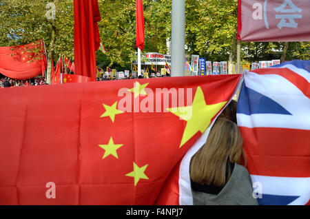 London Oct 2015: Organised Chinese government supporters holding up flags to block photographers' view of protesters.... Stock Photo