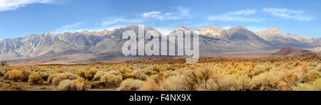 Panorama of the southern tip of the Sierra Nevada Mountains in Central California under a clear blue sky with wispy white clouds Stock Photo