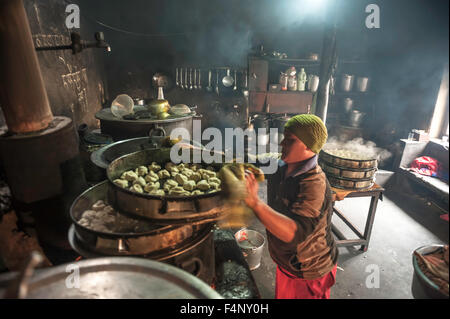 Monk is preparing Tibetan  food in kitchen Stock Photo