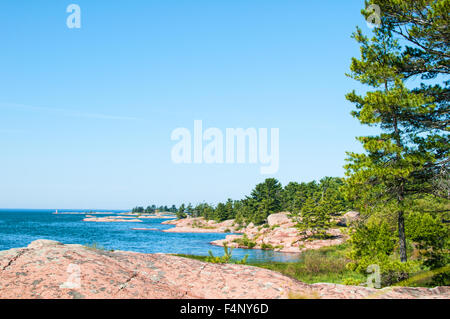 rocks trees and beautiful blue lake in killarney provincial park onatario canada Stock Photo