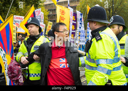 Whitehall, London, October 21st 2015. Hundreds of Chinese supporters waving banners and wearing 'I Love China' T-shirts apparently supplied by the Chinese embassy, face Human rights, Tibetan and Falun Gong protesters as they await the arrival at Downing Street of President Xi Jinpeng. Credit:  Paul Davey/Alamy Live News Stock Photo