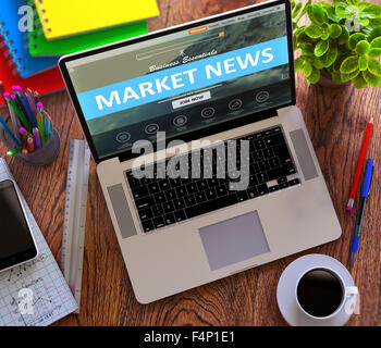 Market News Concept. Modern Laptop and Different Office Supply on Wooden Desktop background. Stock Photo