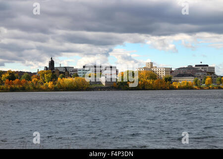 View  Fredericton, New Brunswick, along the Saint John River, Canada showing downtown buildings and  Fall foliage Stock Photo