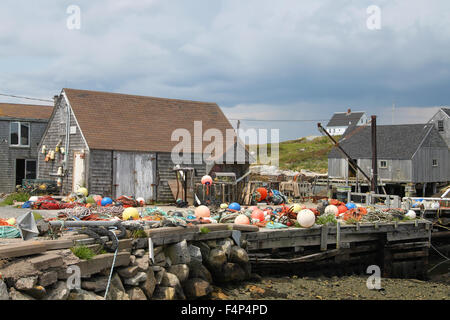 Fishing shacks with colorful buoys along the Atlantic Shore in Peggy's Cove, Nova Scotia, Canada, Stock Photo