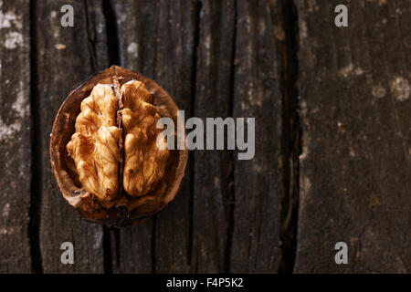 Delicious walnut opened on an old wooden table Stock Photo