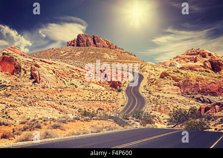 Retro stylized picture of a country road, travel concept, USA. Stock Photo