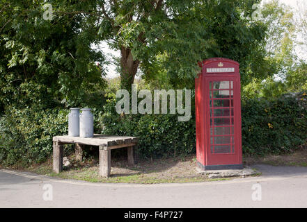 Crantock village red telephone box and milk churns, Cornwall, England, UK Stock Photo