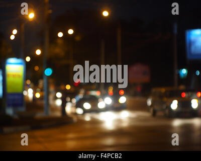 Abstract colored lights from moving vehicles. Blurred image of glare from the headlights and traffic signals for use as a backgr Stock Photo