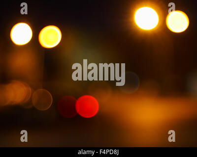 Abstract blur image of round spots of bright multicolored lights on night road closeup Stock Photo