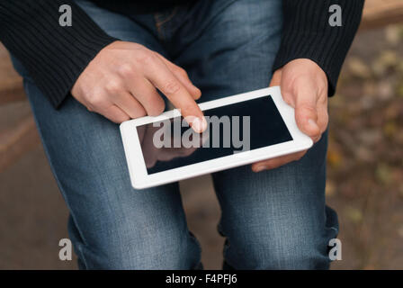 Man with a tablet in his hand close-up on the street. Stock Photo