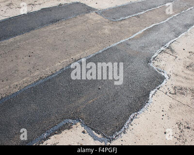 Repair pavement and laying new asphalt patching method outdoors Stock Photo