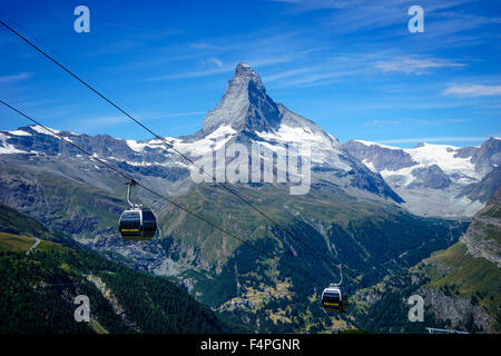 Cable cars soar under Matterhorn peak. July, 2015. Matterhorn, Switzerland. Stock Photo