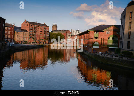View from Leeds Bridge looking down river with flats and offices converted from warehouses Stock Photo