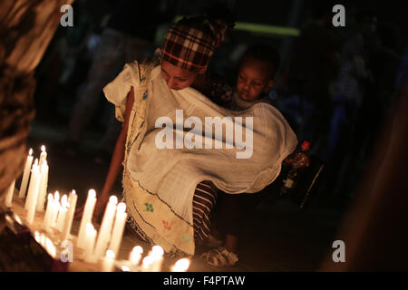 Jerusalem, Israel. 21st Oct, 2015. Members of the Eritrean community in Israel light candles during a memorial ceremony for Eritrean asylum seeker Habtom Zarhum in Tel Aviv, Israel, on Oct. 21, 2015. Zarhum died of his injuries after he was shot by an Israeli security guard at a bus station in the southern city of Be'er Sheva after being mistaken as an assailant in an attack that killed an Israeli soldier. An angry mob then hit him, kicked his head and threw chairs and a bench at him. Credit:  JINI/Daniel Bar-On/Xinhua/Alamy Live News Stock Photo