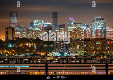 Jersey City skyline rise behind Hoboken and Weehawken cities.