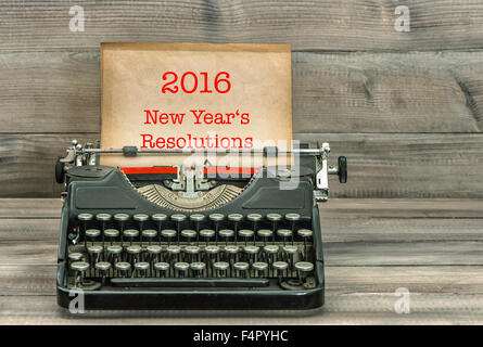 Typewriter with white paper page on wooden table. Sample text 2016 New Year's Resolutions. Vintage style toned picture Stock Photo