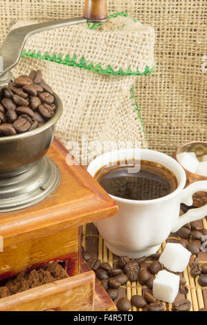Coffee  in various forms around vintage coffee grinder. Ground coffee in a drawer Stock Photo