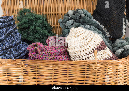 Winter accessories in a wooden basket ready for cold weather Stock Photo