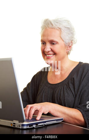 A senior woman working on a laptop Stock Photo